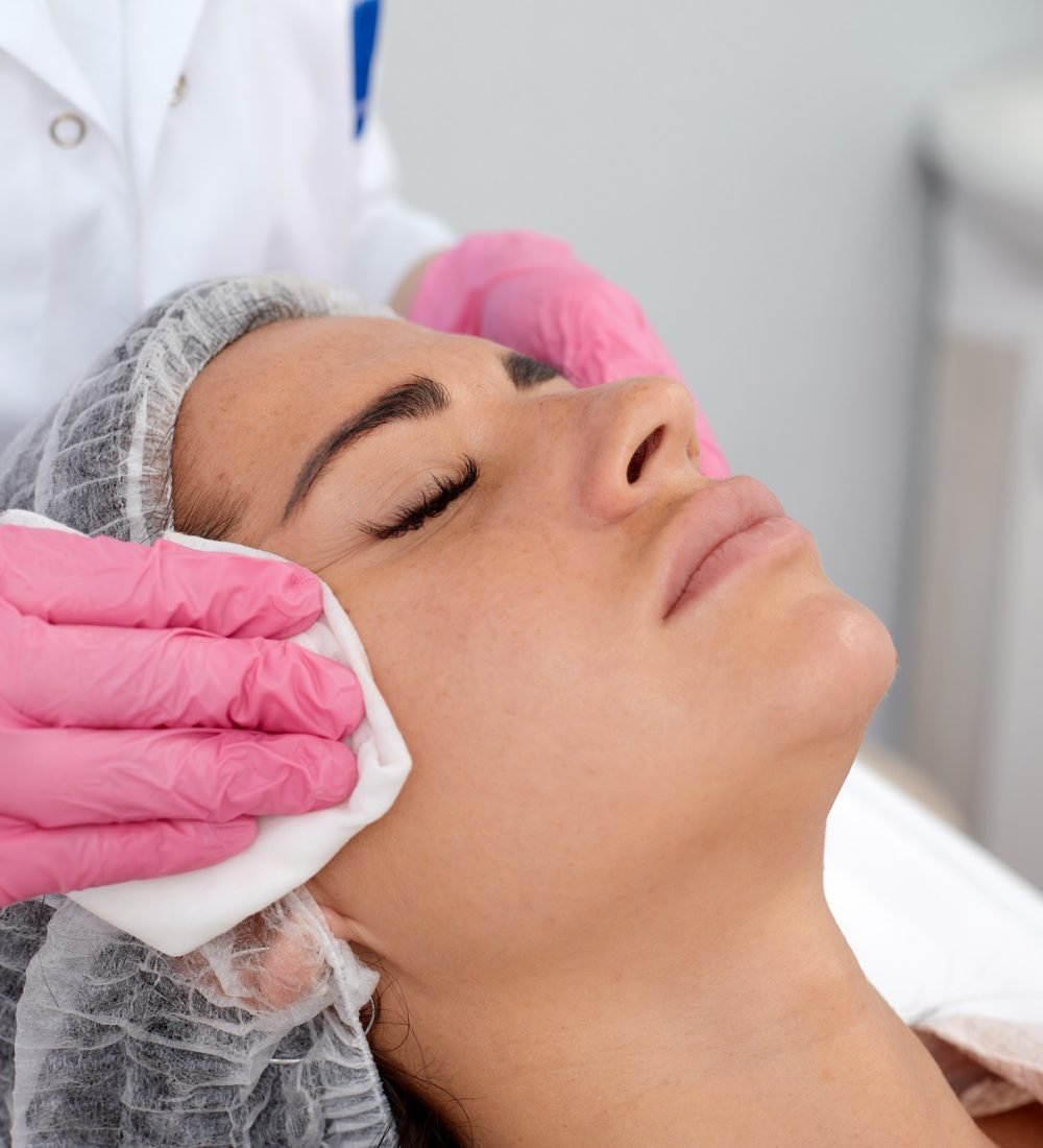 Woman having cleaning facial treatment in spa